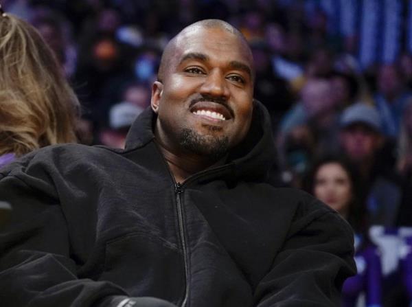 FILE - Kanye West, known as Ye, watches the first half of an NBA basketball game between the Washington Wizards and the Los Angeles Lakers, March 11, 2022, in Los Angeles. Adidas CEO Bjørn Gulden said on a recent podcast that he didn't believe that Ye “meant what he said” when he made a series of antisemitic remarks in 2022. (AP Photo/Ashley Landis, File)