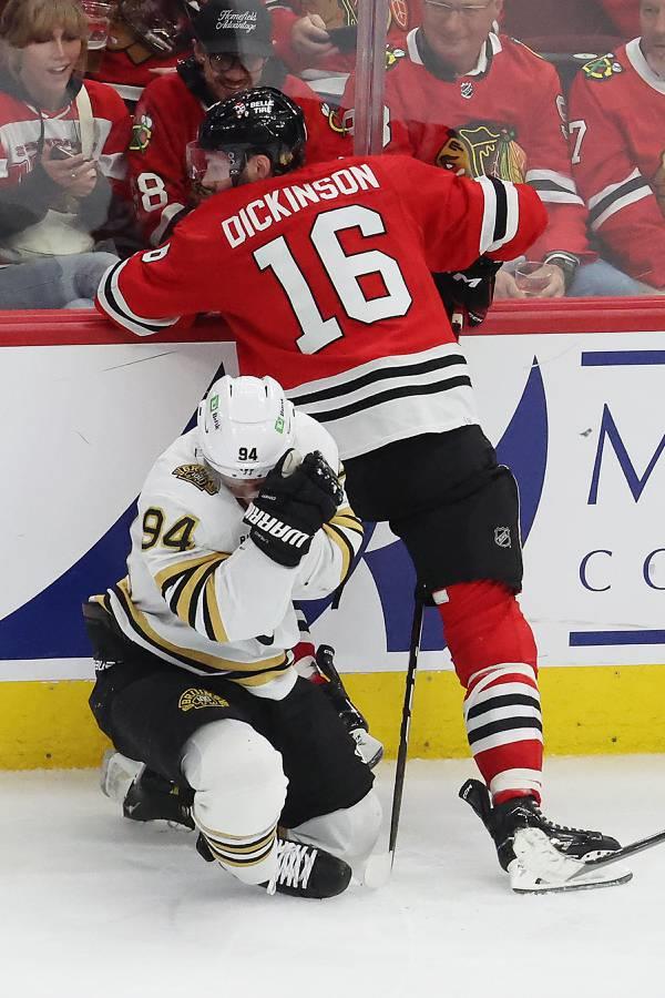 Bruins center Jakub Lauko gets up slowly after a collision as Blackhawks center Jason Dickinson hovers nearby in the third period at the United Center on Oct. 24, 2023. 